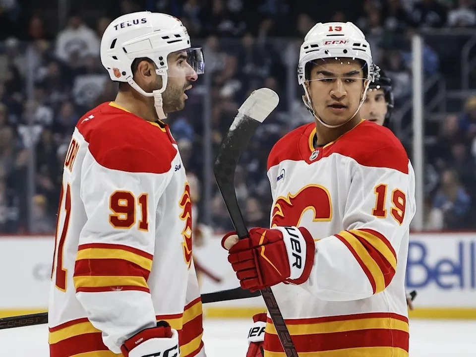 The Flames’ Nazem Kadri and Zayne Parekh celebrate Kadri’s goal on Friday.