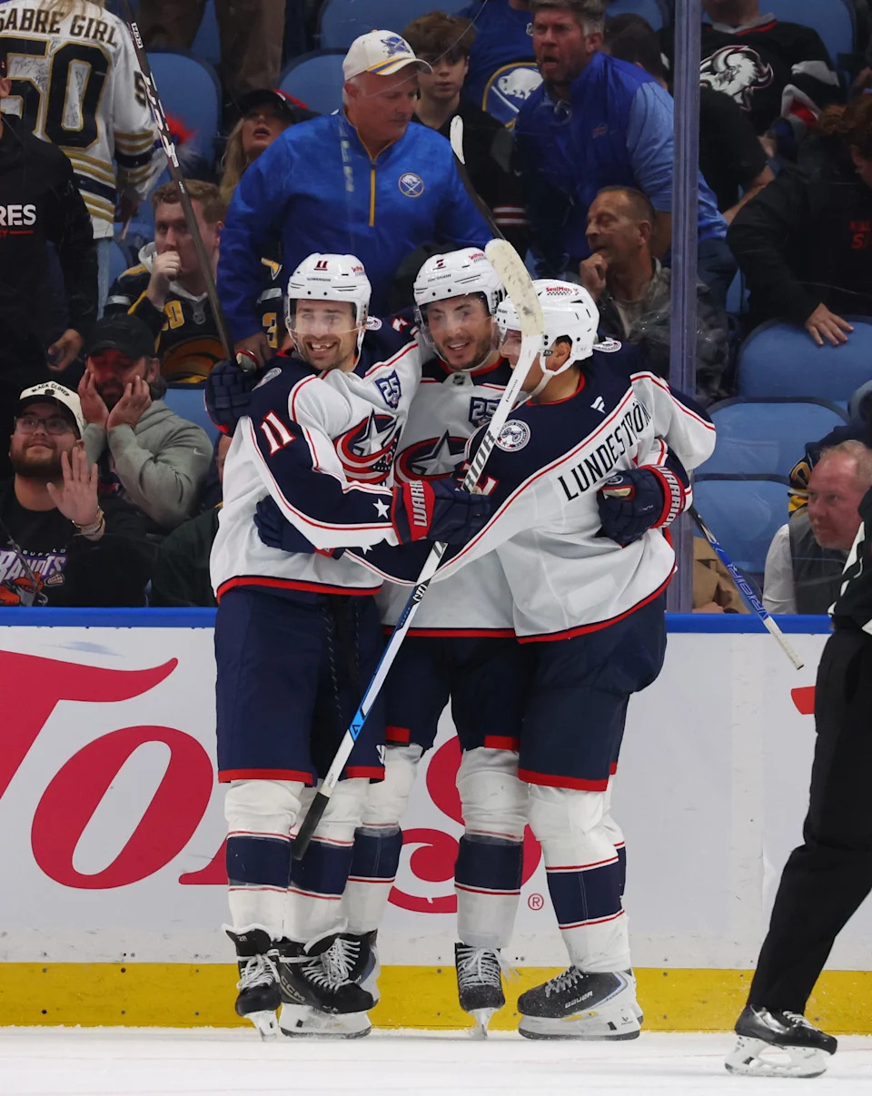 Oct 28, 2025; Buffalo, New York, USA; Columbus Blue Jackets left wing Miles Wood (11) celebrates his overtime goal with teammates against the Buffalo Sabres at KeyBank Center. Mandatory Credit: Timothy T. Ludwig-Imagn Images