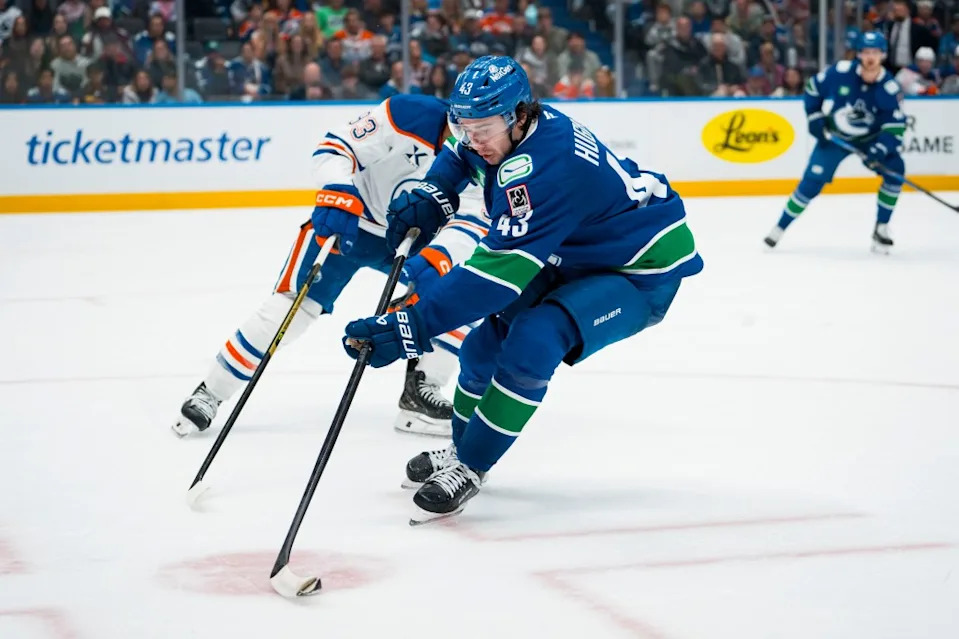 Canucks defenseman Quinn Hughes (43) handles the puck against the Edmonton Oilers. Bob Frid-Imagn Images