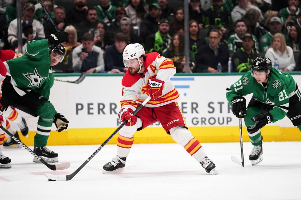 Calgary Flames defenseman Rasmus Andersson (4) controls the puck on an attack as Dallas Stars'...