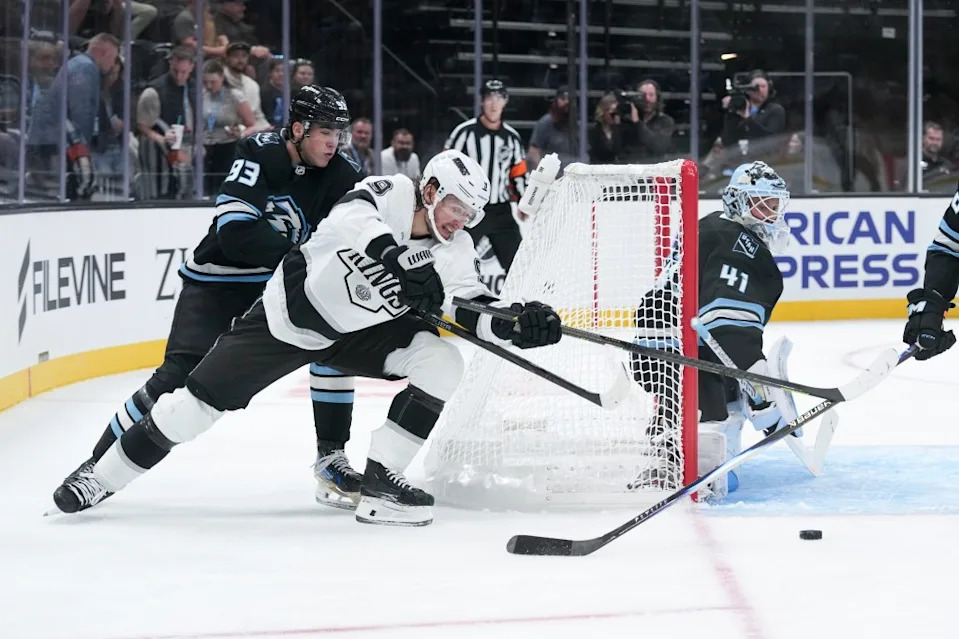 Adrian Kempe #9 of the Los Angeles Kings and Gabe Smith #93 of the Utah Mammoth fight for the puck. NHLI via Getty Images