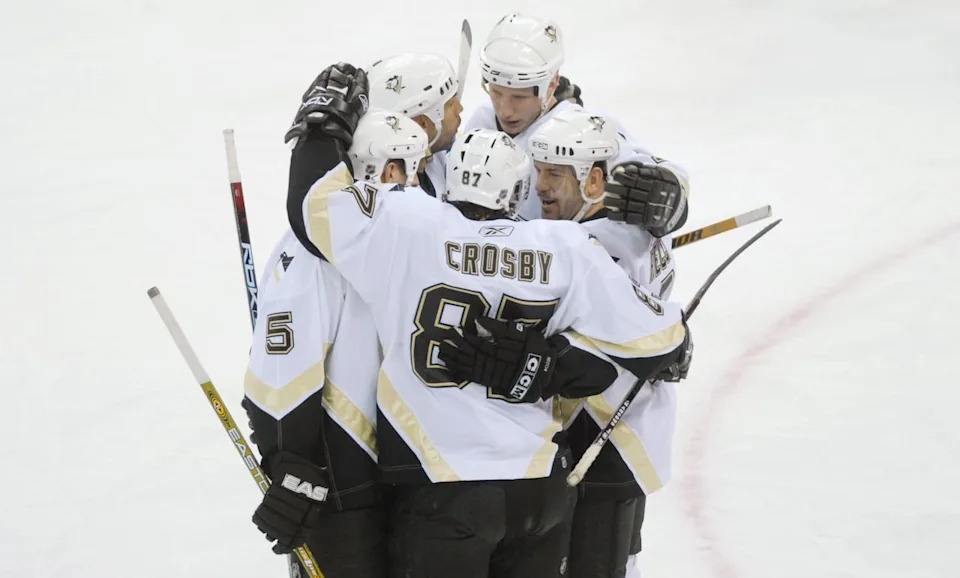 Sidney Crosby, 87, celebrates his 200th career point in a March 2, 2007, game, with teammates, including Alain Nasreddine, second from left.