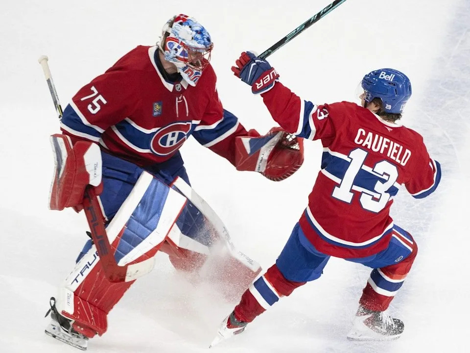 Canadiens’ Cole Caufield celebrates his overtime goal against the Nashville Predators with Jakub Dobes in Montreal on Oct. 16, 2025.