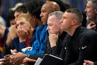 Denver Nuggets head coach Michael Malone, second from front, looks on with assistant coaches...