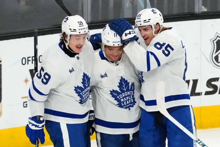 Feb 22, 2024; Las Vegas, Nevada, USA; Toronto Maple Leafs center Max Domi (11) celebrates with left wing Tyler Bertuzzi (59) and defenseman William Lagesson (85) after scoring a goal against the Vegas Golden Knights during the first period at T-Mobile Arena. Mandatory Credit: Stephen R. Sylvanie-Imagn Images