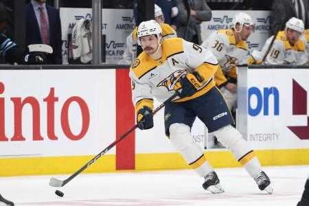 Apr 10, 2025; Salt Lake City, Utah, USA; Nashville Predators left wing Filip Forsberg (9) brings the puck up the ice against the Utah Hockey Club during the third period at Delta Center. Mandatory Credit: Rob Gray-Imagn Images