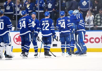 Several members of the Toronto Maple Leafs celebrating their victory over Montreal with goaltender Anthony Stolarz.
