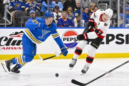 Oct 2, 2025; St. Louis, Missouri, USA; Ottawa Senators left wing Brady Tkachuk (7) controls the puck against St. Louis Blues defenseman Logan Mailloux (23) during the third period at Enterprise Center. Mandatory Credit: Jeff Curry-Imagn Images