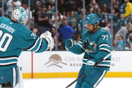 Oct 11, 2025; San Jose, California, USA; San Jose Sharks right wing Ryan Reaves (75) celebrates with goaltender Yaroslav Askarov (left) after scoring a goal against the Anaheim Ducks during the first period at SAP Center at San Jose. Mandatory Credit: Darren Yamashita-Imagn Images