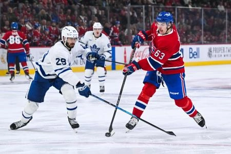 Sep 25, 2025; Montreal, Quebec, CAN; Montreal Canadiens left wing Florian Xhekaj (63) shoots the puck beside Toronto Maple Leafs forward Bo Groulx (29) during the third period at Bell Centre. Mandatory Credit: David Kirouac-Imagn Images