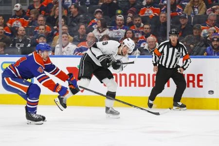 Los Angeles Kings' star Adrian Kempe fires puck into offensive-zone in a game versus the Edmonton Oilers Los Angeles Kings' star Adrian Kempe fires puck into offensive-zone in a game versus the Edmonton Oilers
