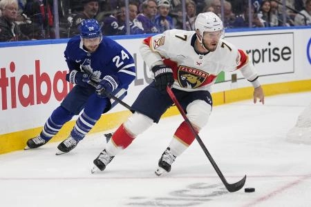 Florida Panthers defenseman Dmitry Kulikov carries the puck past Toronto Maple Leafs forward Scott Laughton