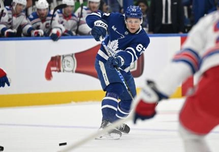 Oct 16, 2025; Toronto, Ontario, CAN; Toronto Maple Leafs forward Easton Cowan (53) passes the puck against the New York Rangers in the first period at Scotiabank Arena. Mandatory Credit: Dan Hamilton-Imagn Images