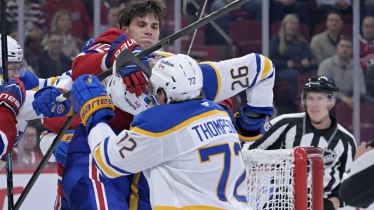 Oct 20, 2025; Montreal, Quebec, CAN; Montreal Canadiens forward Juraj Slafkovsky (20) fights with Buffalo Sabres defenseman Rasmus Dahlin (26) during the third period at the Bell Centre. Mandatory Credit: Eric Bolte-Imagn Images