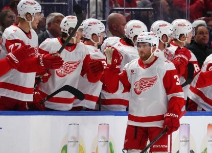 Oct 22, 2025; Buffalo, New York, USA; Detroit Red Wings left wing J.T. Compher (37) celebrates his goal with teammates during the second period against the Buffalo Sabres at KeyBank Center. Mandatory Credit: Timothy T. Ludwig-Imagn Images