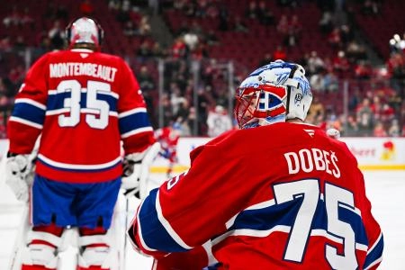 Jan 28, 2025; Montreal, Quebec, CAN; Montreal Canadiens goalie Jakub Dobes (75) stands behind goalie Sam Montembeault (35) during warm-up before the game against the Winnipeg Jets at Bell Centre. Mandatory Credit: David Kirouac-Imagn Images