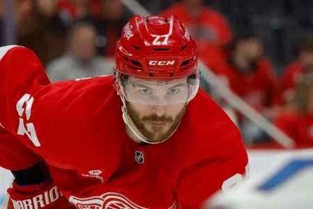Dec 7, 2024; Detroit, Michigan, USA; Detroit Red Wings center Michael Rasmussen (27) looks on during a face off against the Colorado Avalanche in the second period at Little Caesars Arena. Mandatory Credit: Brian Bradshaw Sevald-Imagn Images
