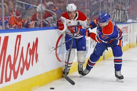 Oct 23, 2025; Edmonton, Alberta, CAN; Montreal Canadiens forward Brendan Gallagher (11) and Edmonton Oilers defensemen Brett Kulak (27) battle along the boards for a loose puck during the second period at Rogers Place. Mandatory Credit: Perry Nelson-Imagn Images
