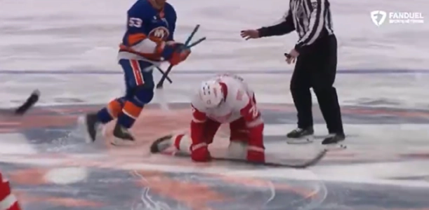 Michael Rasmussen on the ice after a cross check from Casey Cizikas in a game between the Detroit Red Wings and the New York Islanders. Michael Rasmussen on the ice after a cross check from Casey Cizikas in a game between the Detroit Red Wings and the New York Islanders.