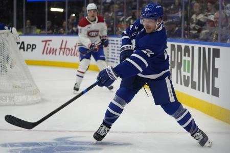 Sep 27, 2025; Toronto, Ontario, CAN; Toronto Maple Leafs defenseman Jake McCabe (22) clears the puck against the Montreal Canadiens during the second period at Scotiabank Arena. Mandatory Credit: John E. Sokolowski-Imagn Images