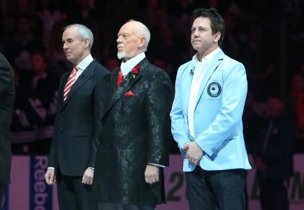Former player Doug Gilmour (93) and Don Cherry (middle) and Ron MacLean (on left) stand for the playing of the anthems after ceremony marking the 60th anniversary of Hockey Night In Canada before the Toronto Maple Leafs game against the Boston Bruins at the Air Canada Centre.