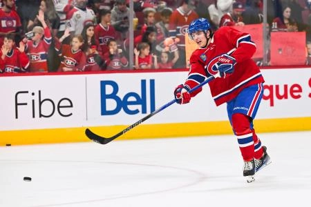 Sep 30, 2023; Montreal, Quebec, CAN; Montreal Canadiens defenseman David Reinbacher (64) shoots a puck during warm-up before the game against the Toronto Maple Leafs at Bell Centre. Mandatory Credit: David Kirouac-Imagn Images