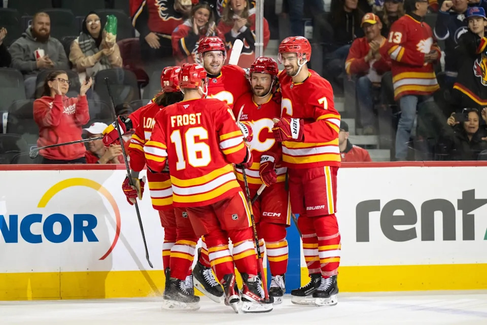 Calgary Flames defenseman Rasmus Andersson (4) celebrates a goal against the Winnipeg Jets with center Morgan Frost (16), left wing Ryan Lomberg (70), right wing Adam Klapka (43), and defenseman Kevin Bahl (7) during the second period at Scotiabank Saddledome.