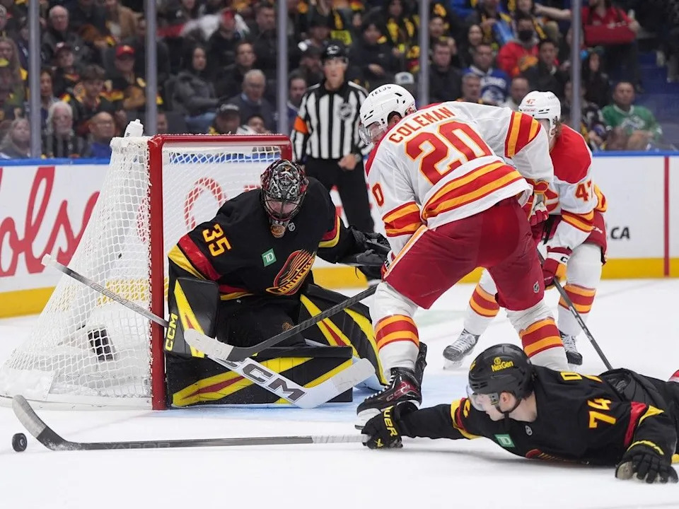  Vancouver Canucks goalie Thatcher Demko (35) watches as Jake DeBrusk (74) swats the puck away from Calgary Flames’ Blake Coleman (20) during the second period of an NHL hockey game in Vancouver, on Thursday, October 9, 2025.