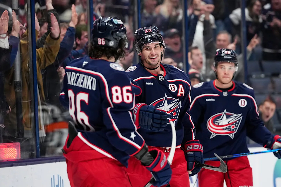 Blue Jackets center Sean Monahan (middle) celebrates scoring a goal with right wing Kirill Marchenko (86) against the Oilers on Monday, Oct. 28.