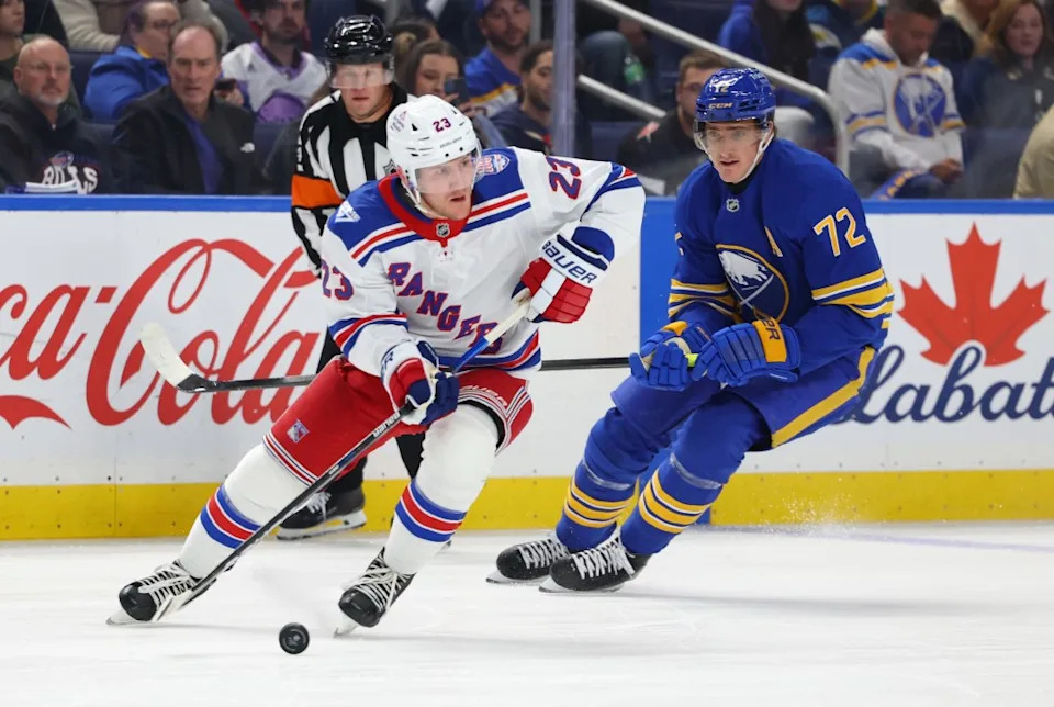 New York Rangers defenseman Adam Fox (23) looks to make a pass as Buffalo Sabres center Tage Thompson (72) defends during the first period at KeyBank Center. Timothy T. Ludwig-Imagn Images