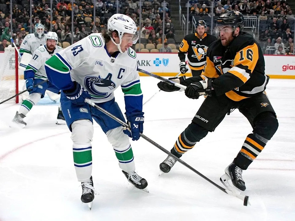  Quinn Hughes is pressured by Penguins forward Justin Brazeau during Wednesday game in Pittsburgh.