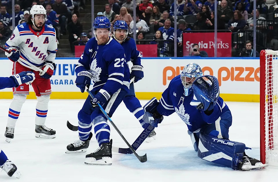  Maple Leafs goaltender Anthony Stolarz (41) makes a save as New York Rangers’ Mika Zibanejad (93) and Toronto Maple Leafs’ Jake McCabe (22) and Chris Tanev (8) look on during first period NHL hockey action in Toronto on Thursday, October 16, 2025. (THE CANADIAN PRESS/Nathan Denette)
