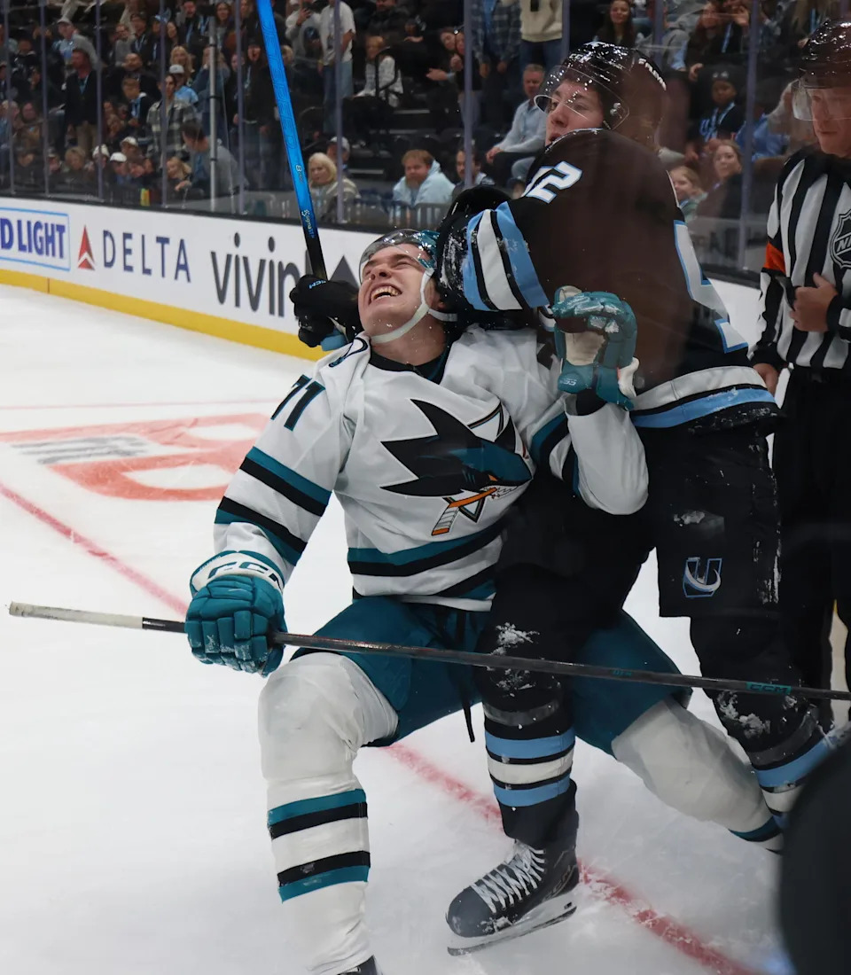 Oct 17, 2025; Salt Lake City, Utah, USA; San Jose Sharks center Macklin Celebrini (71) and Utah Mammoth center Logan Cooley (92) fight during the second period at Delta Center. (Rob Gray-Imagn Images)