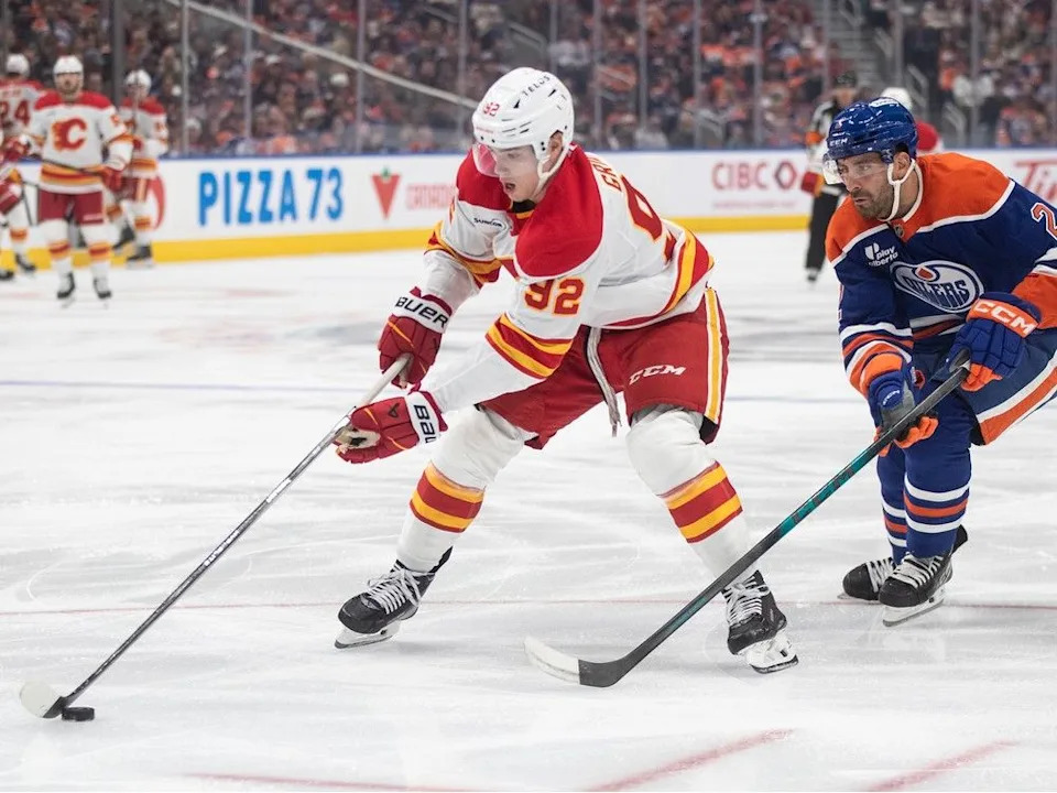  Making his NHL debut, Flames forward Matvei Gridi is chased by Oilers defenceman Evan Bouchard on Wednesday.