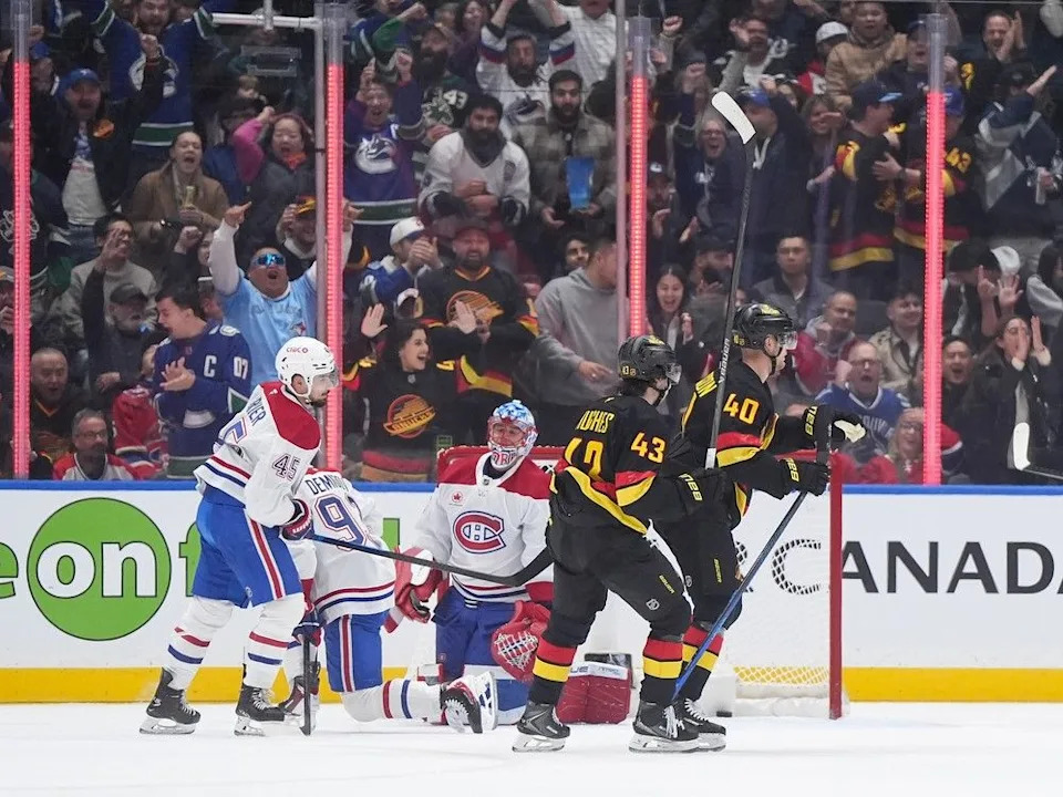  Vancouver Canucks’ Elias Pettersson and Quinn Hughes celebrate Pettersson’s goal against Montreal Canadiens goalie Jakub Dobes on Saturday.
