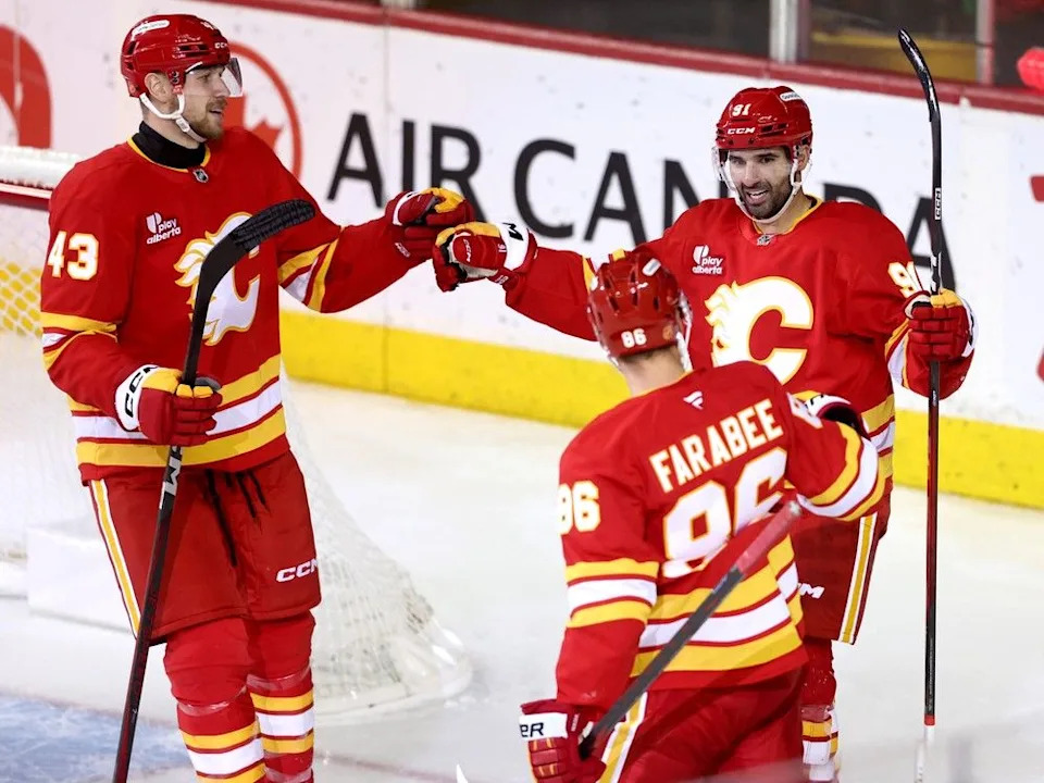 Flames forward Nazem Kadri (back right) celebrates one of his two goals on Friday, with Joel Farabee and Adam Klapka.