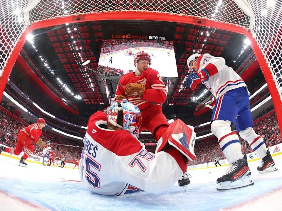  Red Wings’ J.T. Compher runs into Canadiens goalie Jakub Dobes during the first period in Detroit on Oct. 9.