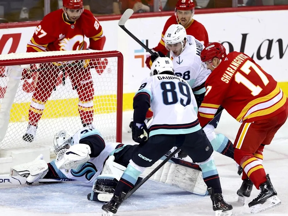 Flames forward Yegor Sharangovich battles the Kraken on Sept. 23, 2025.