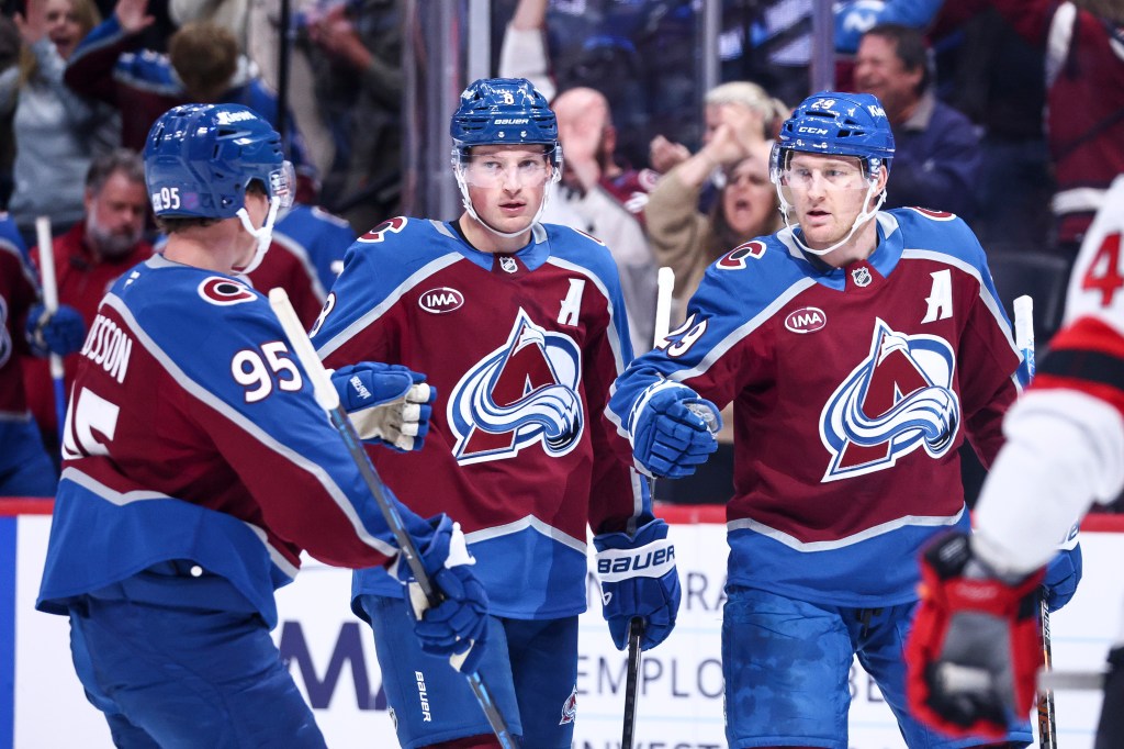 Victor Olofsson, Cale Makar, and Nathan MacKinnon of the Colorado Avalanche celebrate a goal.