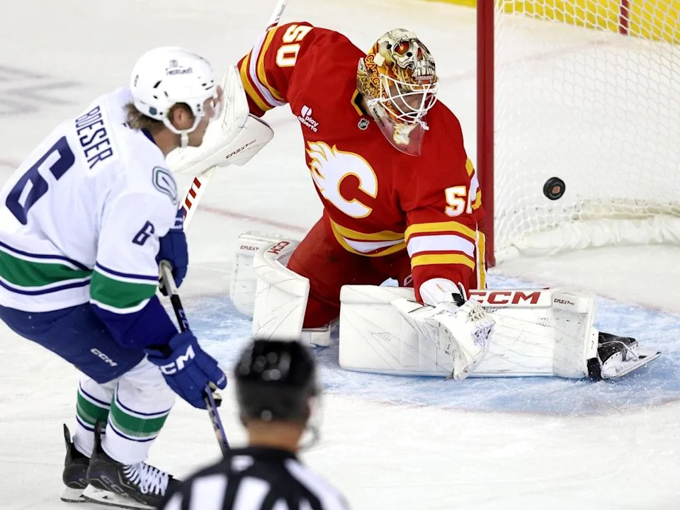  Calgary Flames goalie Ivan Prosvetov is scored on by Vancouver Canucks forward Brock Boeser in pre-season action at the Scotiabank Saddledome in Calgary on Wednesday, Oct. 1, 2025.