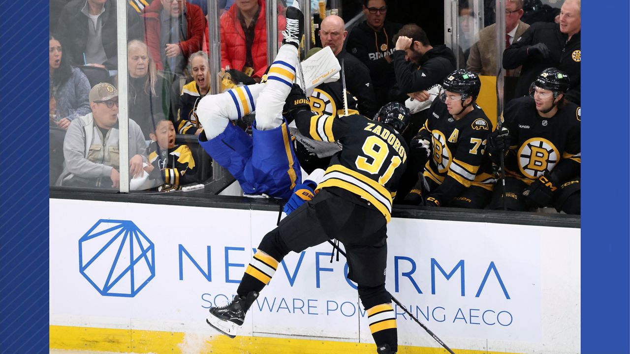 Boston Bruins' Nikita Zadorov (91) checks Buffalo Sabres' Owen Power, center left, during the first period of an NHL hockey game, Saturday, Oct. 11, 2025, in Boston. (AP Photo/Michael Dwyer)