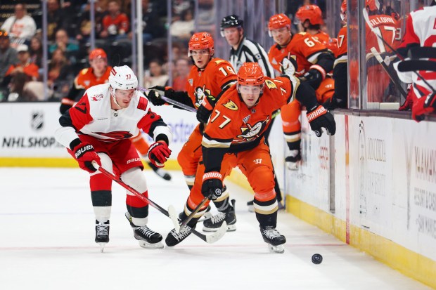 Ducks right wing Frank Vatrano (77) and Carolina Hurricanes right...