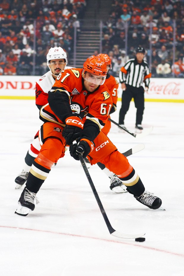 Ducks left wing Cutter Gauthier (61) fights to control the...