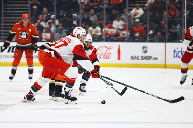 Carolina Hurricanes defenseman Jalen Chatfield (5) and teammate Mark Jankowski...