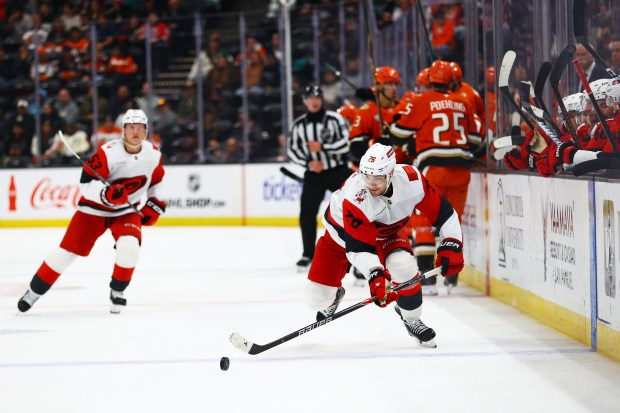Carolina Hurricanes defenseman Sean Walker (26) moves the puck down...