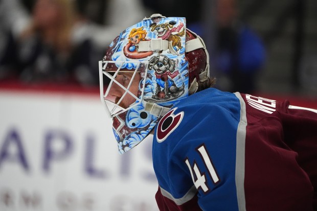 Colorado Avalanche goaltender Scott Wedgewood covers the net in the second period of an NHL hockey game against the Boston Bruins, Saturday, Oct. 18, 2025, in Denver. (AP Photo/David Zalubowski)