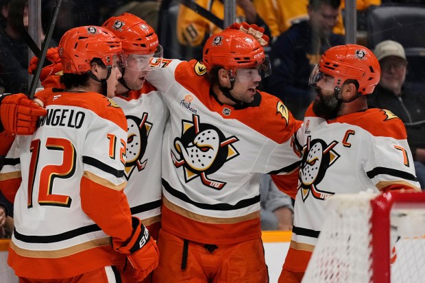 Ducks left wing Ross Johnston, second from left, celebrates his...