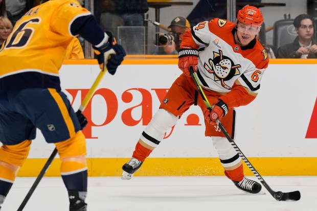 Ducks center Mikael Granlund shoots the puck past Nashville Predators...