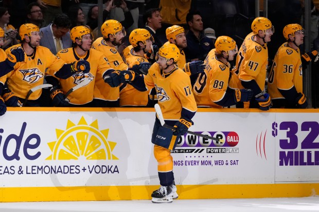 Nashville Predators center Tyson Jost (17) celebrates his goal with...