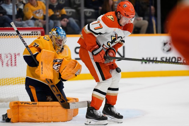 Ducks right wing Frank Vatrano (77) tries to get the...